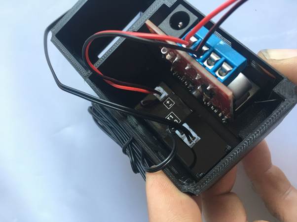 Close-up view of the internal wiring and components of a Fourby multifunction USB clock kit, showing connections and parts layout.